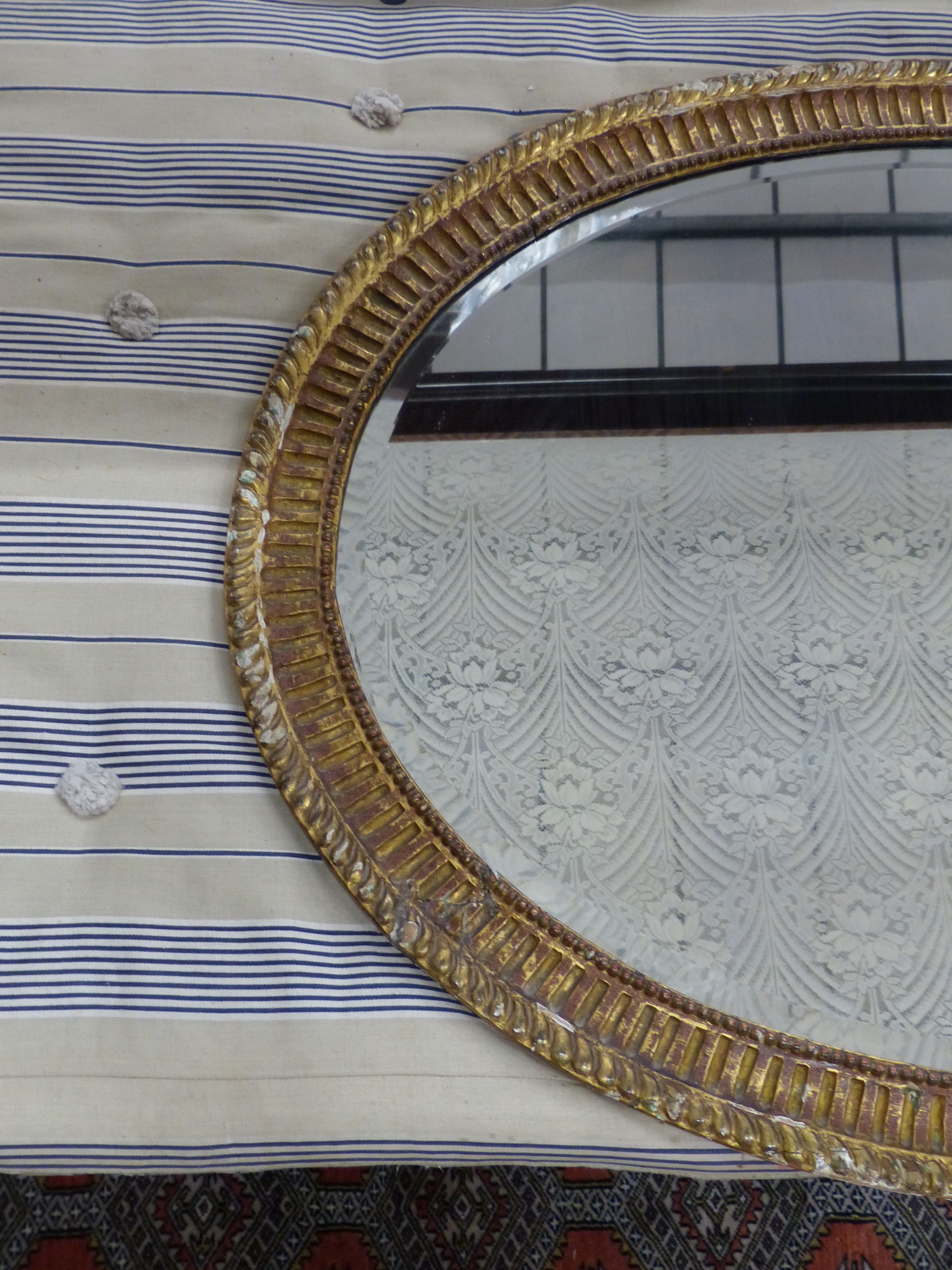 A large George III oval giltwood mirror, width 109cm, height 84cm